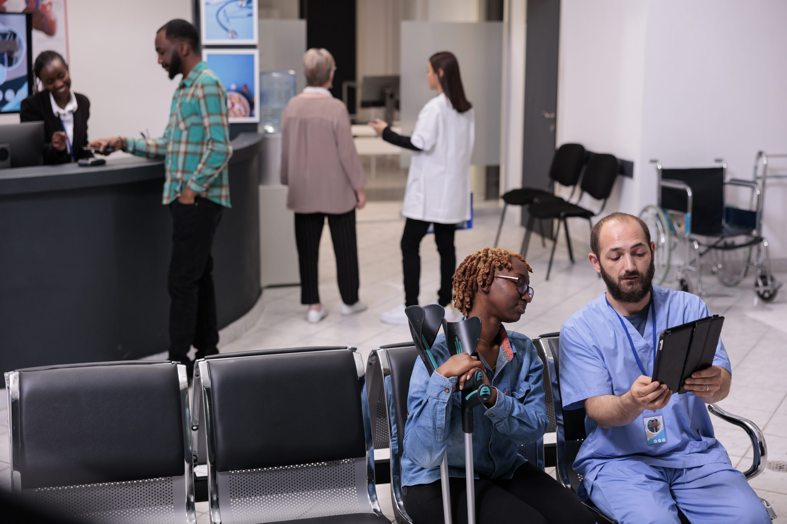 african american patient and nurse looking at tablet